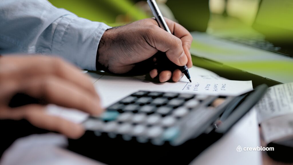 Close-up of tax and payroll documents and a calculator symbolizing international payroll and social security obligations.