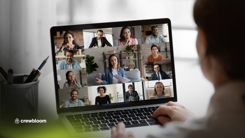 Diverse offshore remote team smiling and engaging in a lively virtual meeting via video call.